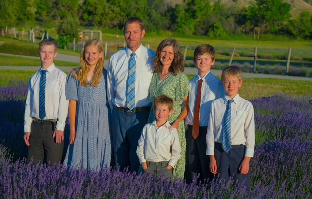 The Downs family standing in the lavender field