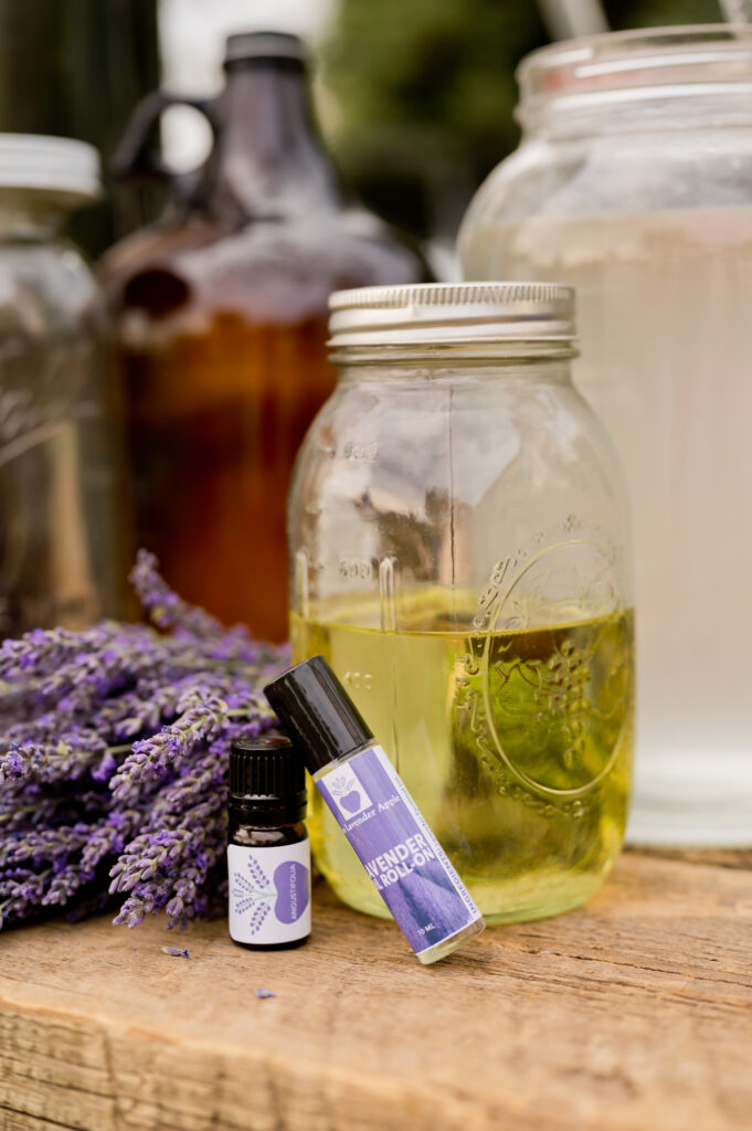 Lavender essential oil and roll-on beside jars and lavender bundles